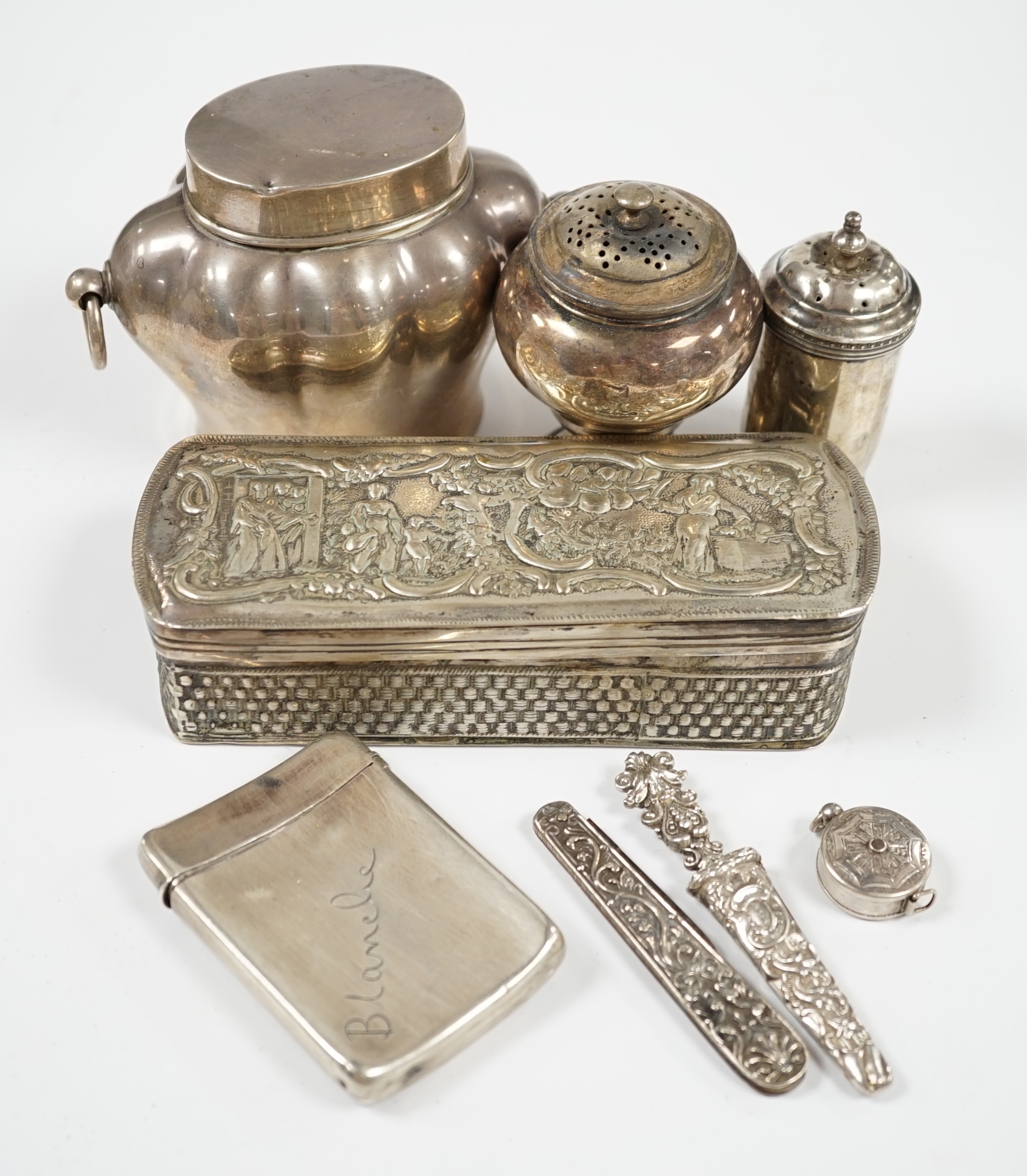 Sundry small silver including an Edwardian silver tea caddy, height 84mm, two silver condiments and four other items including a silver cased tape measure, together with a white metal trinket box. Condition - poor to fai